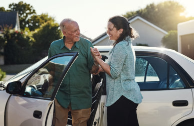 woman assisting elderly man